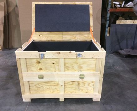 This photo shows a wooden shipping crate with foam padding. The lid opens for easy shipping of art or antique shipping.