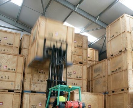 Forklift access wood crate being stacked,  Stacked wood shipping crates stored for internatonal or domestic shipping.